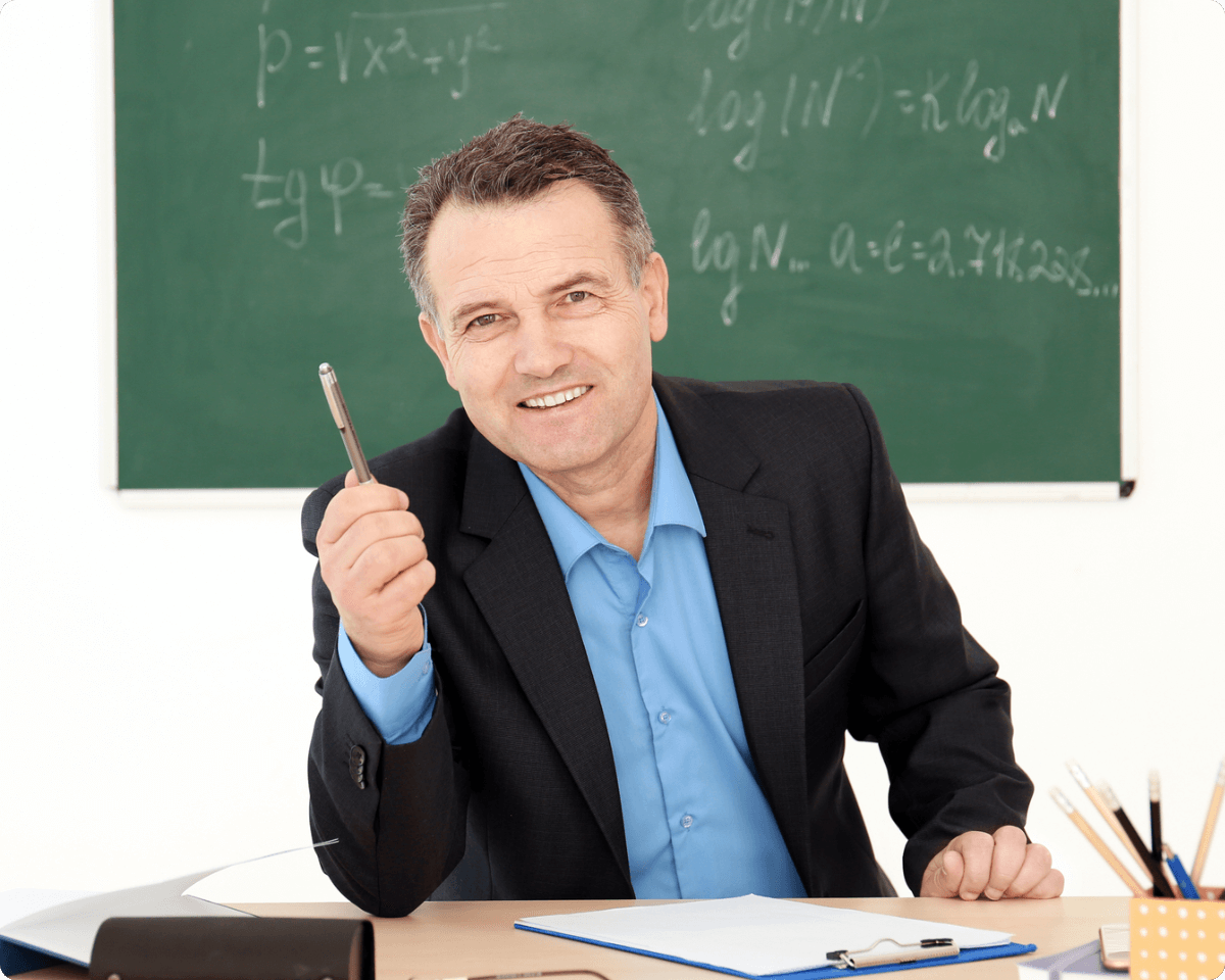 a middle-aged male teacher in a black suit gives a lecture