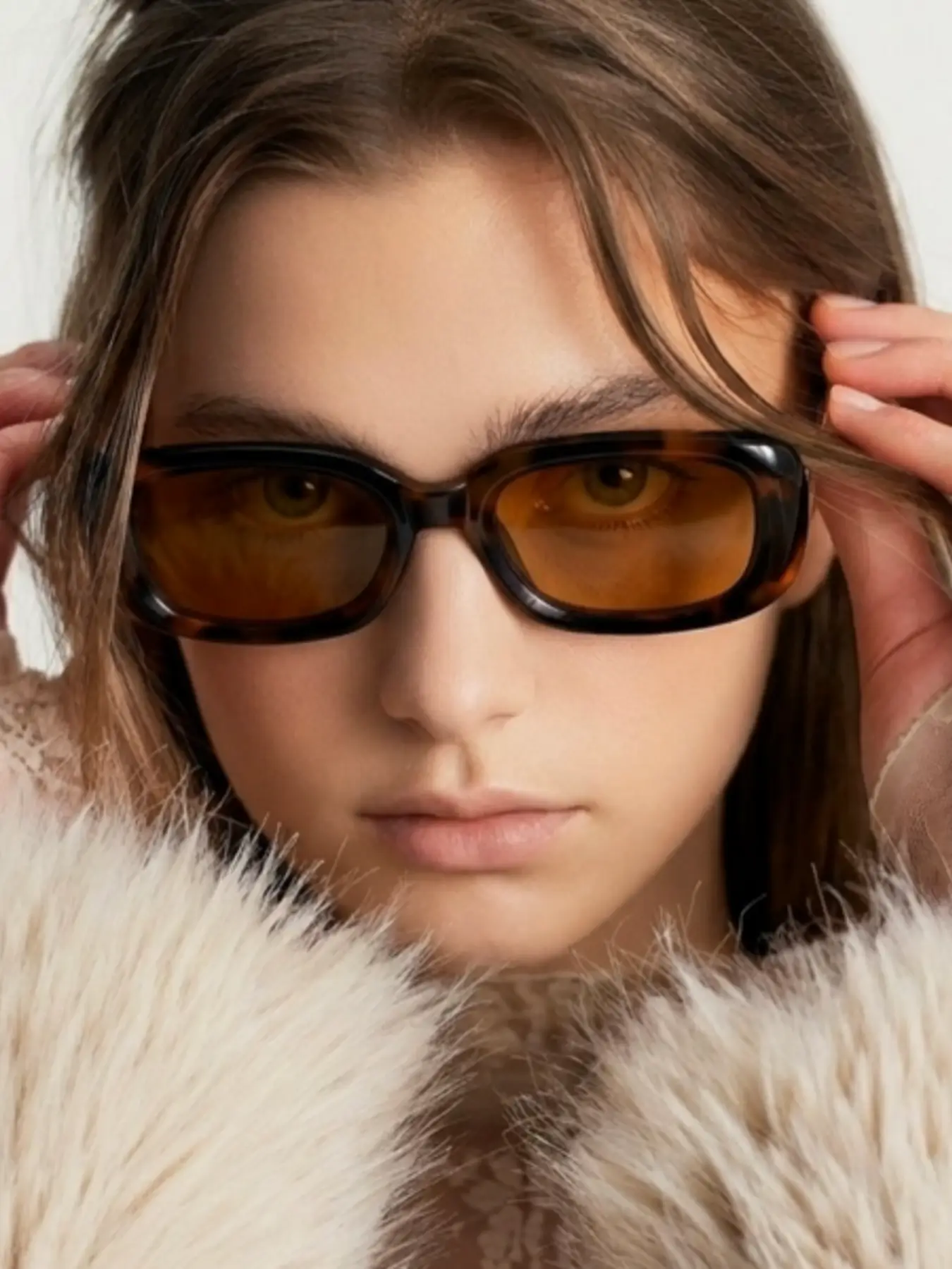 AI generated close-up fashion editorial shot of a model wearing tortoiseshell sunglasses, demonstrating high-resolution e-commerce eyewear photography